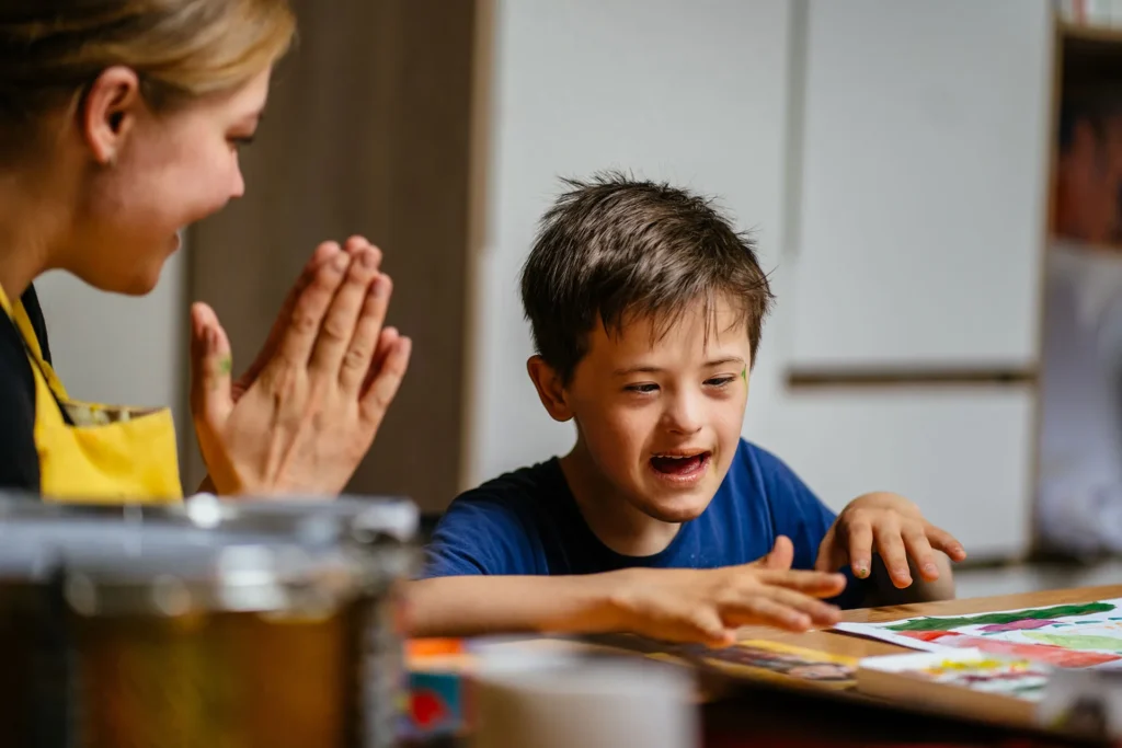 boy working on a puzzle with a teacher